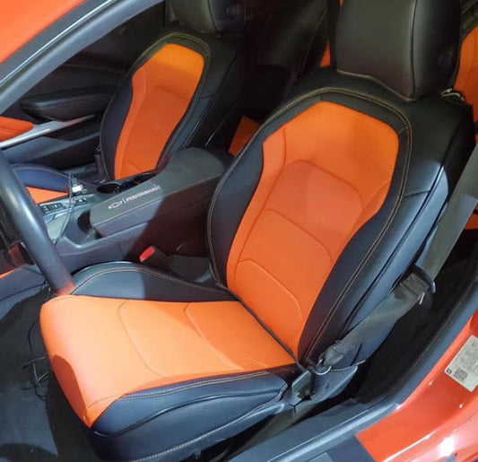 Front seats of Camaro La Coupe 2022 with orange and black artificial Nappa leather seat covers, showing precise custom fit and contrasting stitching.