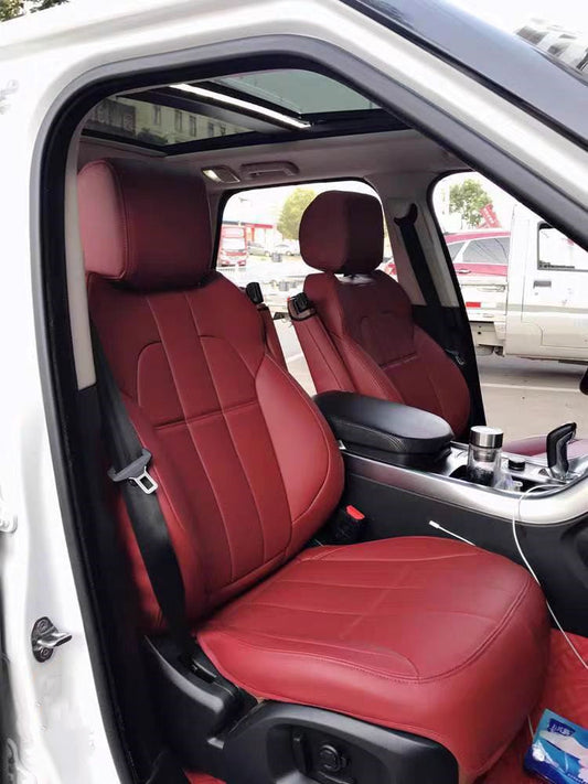 Front seats of a white Range Rover equipped with custom-fitted burgundy artificial nappa leather seat covers