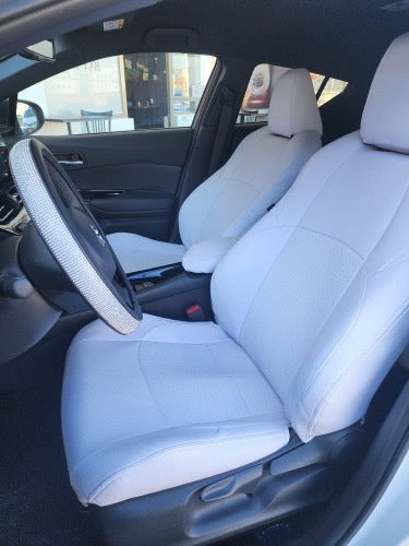 Front seats of Toyota CHR 2024 with custom white artificial Nappa leather seat covers installed