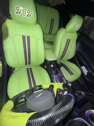 Front seats of Mustang Coupe covered in bright green artificial Nappa leather with black racing stripes and '717' embroidery on headrests