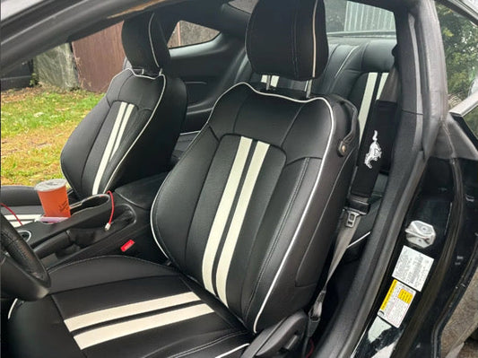 Front seats of a Mustang Coupe featuring black artificial nappa leather seat covers with white racing stripes and piping
