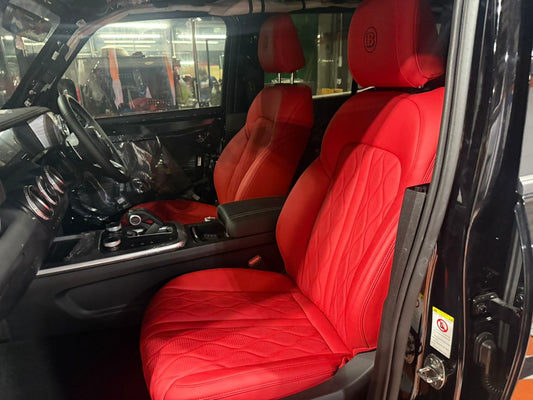 Front seats of Tank 300 with vibrant red artificial nappa leather seat covers featuring diamond stitching and embossed headrest logo
