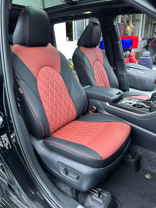 Front seats of Toyota Kluger with black and burgundy custom artificial Nappa leather seat covers featuring diamond quilting and burgundy piping