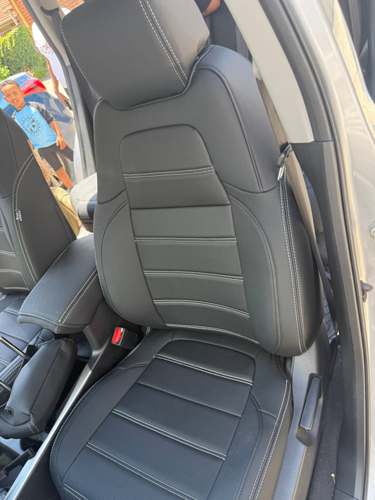 Front passenger seat of Honda CRV 2019 with black custom seat cover featuring white stitching