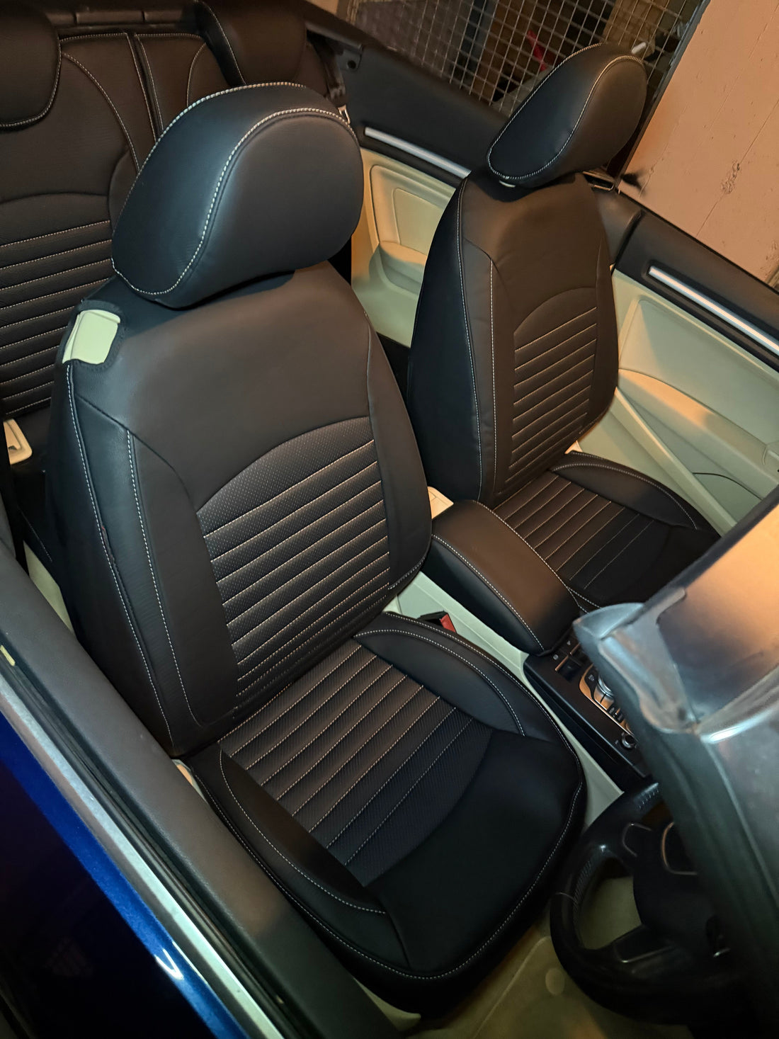 Front seats of Audi A3 Convertible 2014 covered with black artificial nappa leather seat covers featuring beige stitching pinstripe pattern