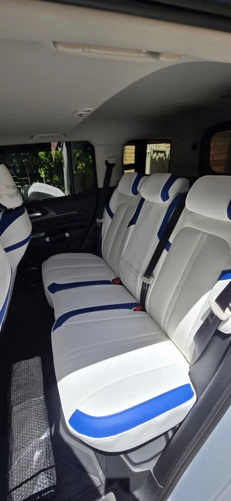 Rear seats of Tank 300 fitted with white seat covers accented with blue stripes on headrest and seat edges