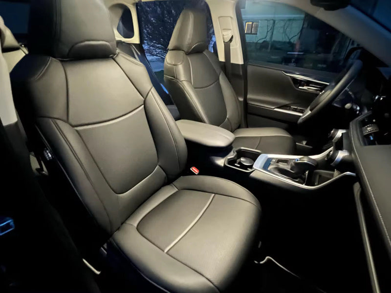 Front seats of 2020 Toyota RAV4 fitted with black artificial Nappa leather seat covers showing detailed stitching and headrest coverage.