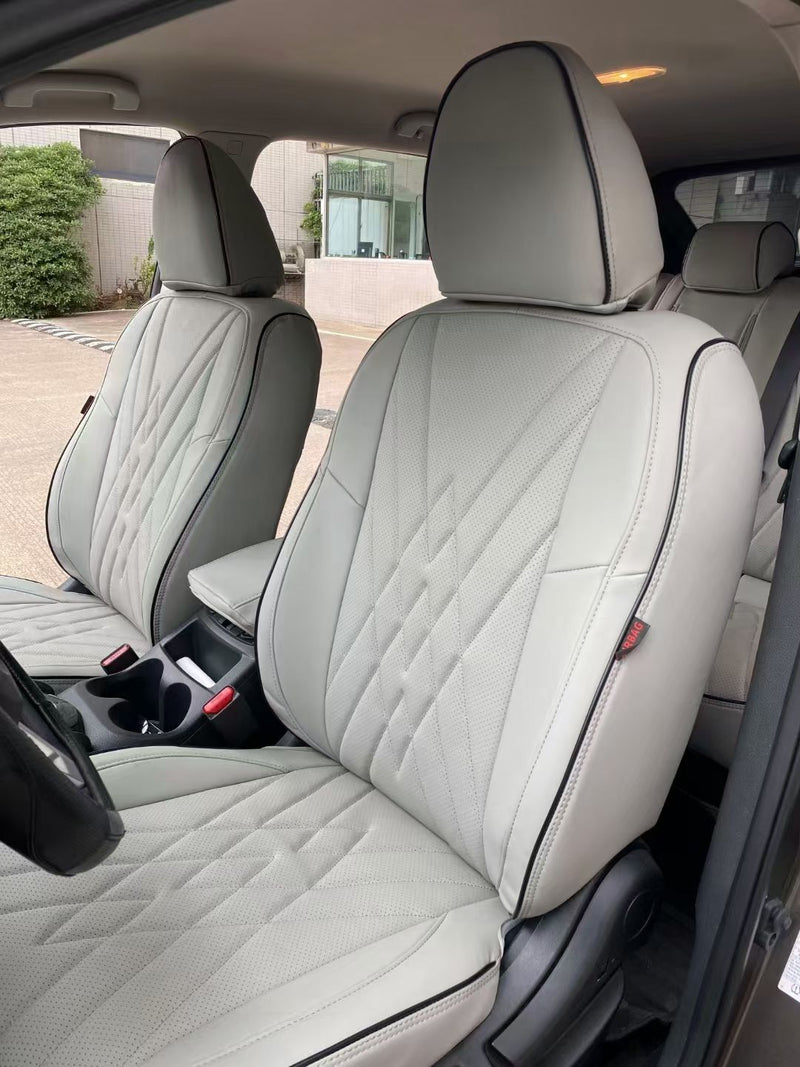 White artificial nappa leather custom seat covers on Nissan Qashqai front seats showing diamond quilting and contrast piping