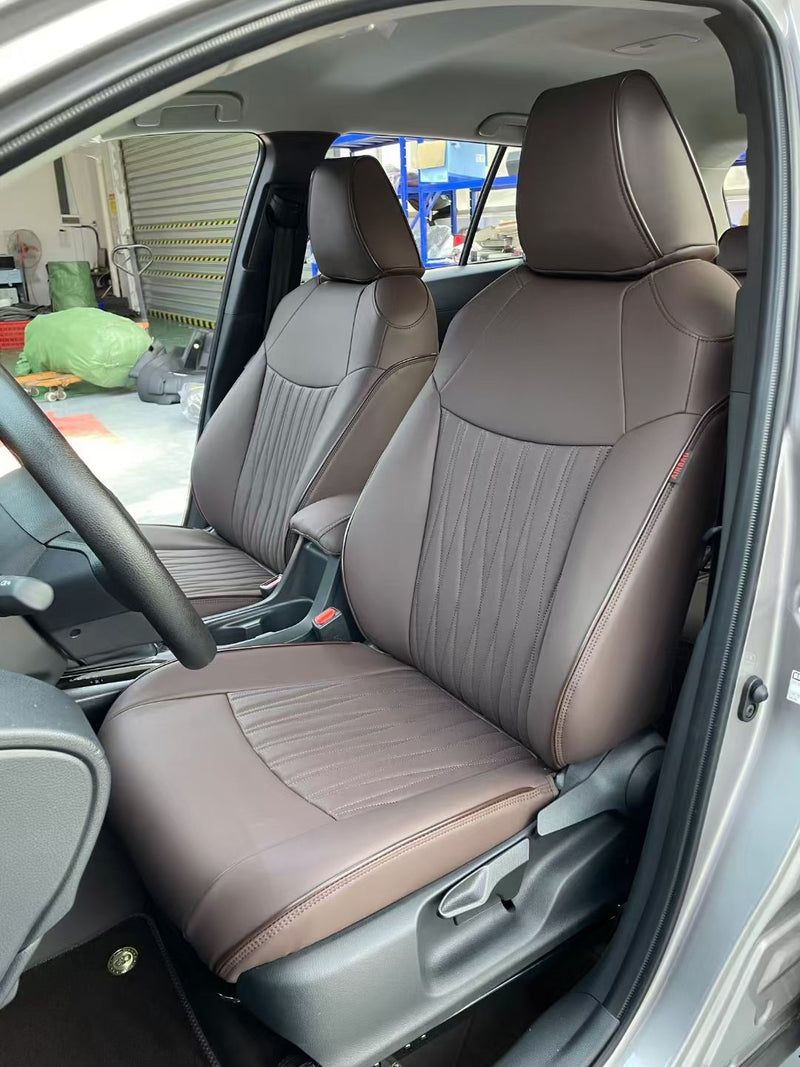 Close-up of coffee-colored artificial nappa leather front seats with vertical stitching in Toyota Corolla