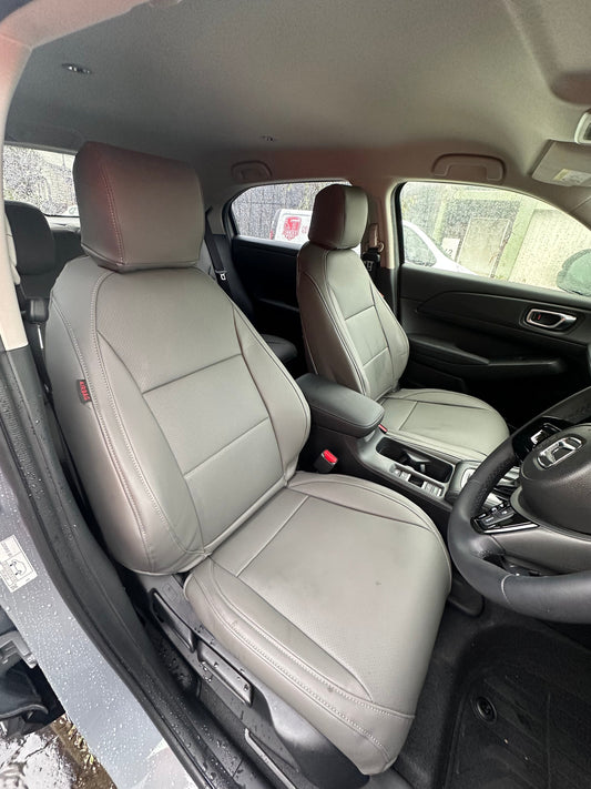Front seats of Honda HRV VI-X 2025 with dark gray artificial nappa leather seat covers, showing detailed stitching