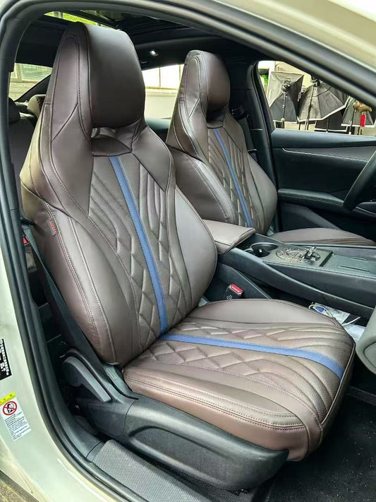 Front seats of BYD Seal fitted with custom coffee brown artificial Nappa leather covers featuring a blue center stripe and diamond stitching