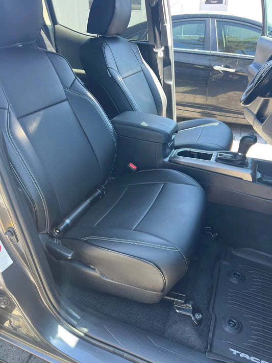 front seats of Toyota Tacoma with black artificial Nappa leather seat covers featuring white stitching