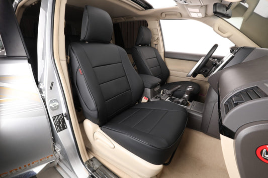 Front seats of Toyota Landcruiser Prado with black custom-fit artificial Nappa leather seat covers