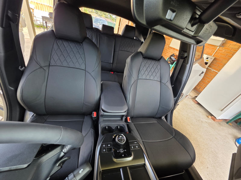 Front seats of Toyota BZ4X 2026 with black artificial Nappa leather seat covers showing diamond stitch pattern