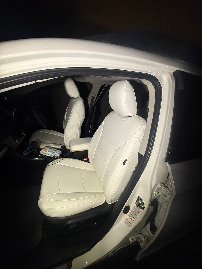 Front seats of 2018 Subaru Outback with white leather custom-fit seat covers