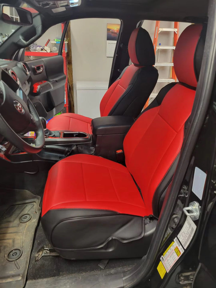Front seats of Toyota Tacoma covered with custom red and black artificial Nappa leather seat covers