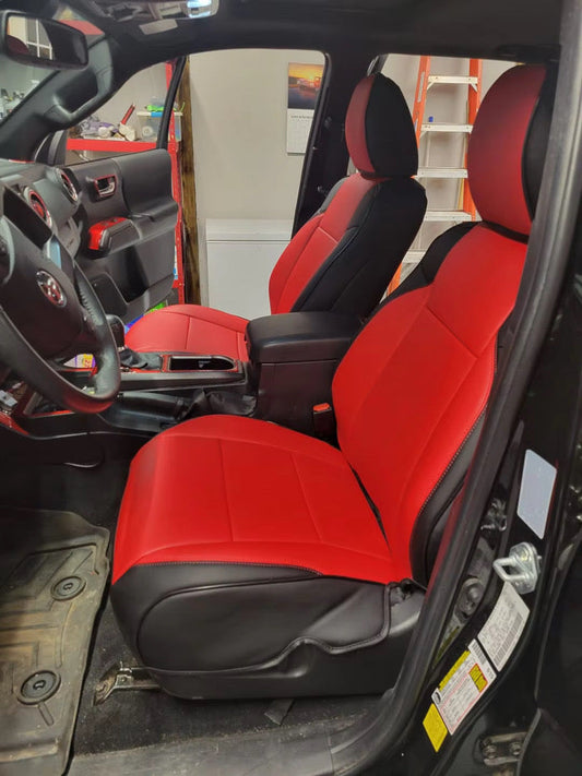 Front seats of Toyota Tacoma covered with custom red and black artificial Nappa leather seat covers