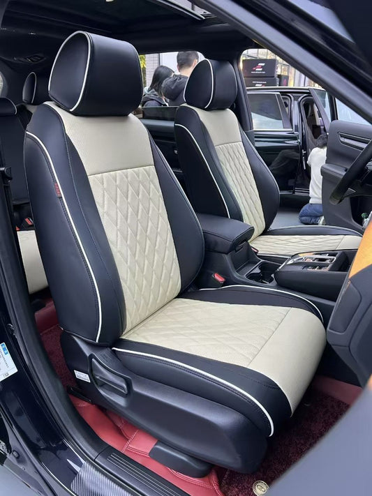 Front seats of Toyota Corolla Cross with navy and cream white artificial nappa leather seat covers featuring diamond quilting and white piping