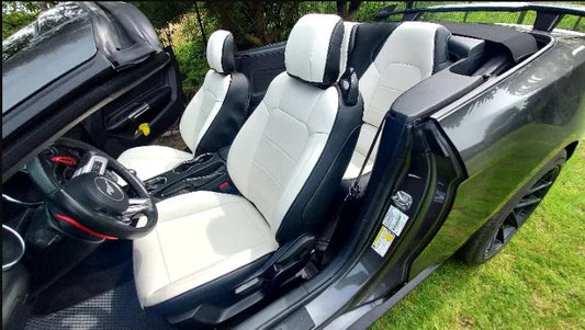 Front seats of a Convertible Mustang fitted with white and black custom artificial nappa leather seat covers