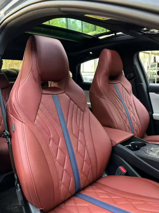 Close-up of front BYD Seal seats covered in burgundy artificial nappa leather with blue stripe
