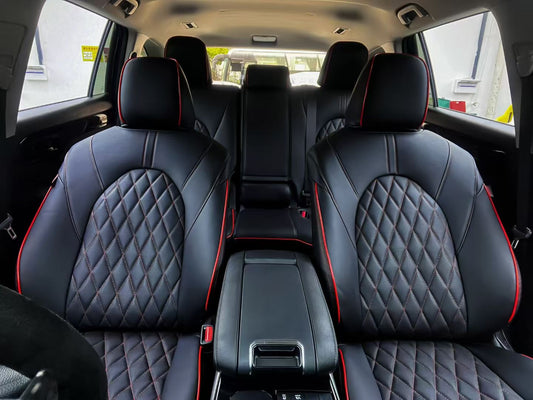 Front view of Toyota Kluger seats with custom black artificial Nappa leather covers featuring diamond stitching and red piping.