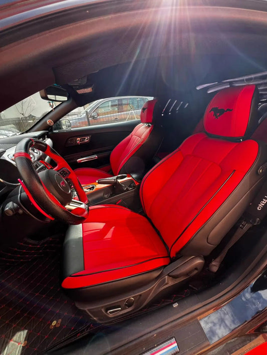 Front seats of Mustang Coupe with red and black custom artificial nappa leather seat covers and Mustang logo on headrests