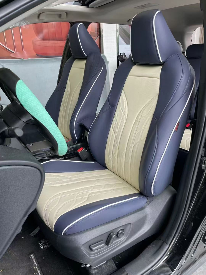 Front custom seat covers in two-tone beige and navy blue artificial Nappa leather on a Toyota Corolla Cross
